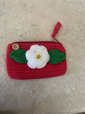 Hand Crafted red crochet wristlet with white flower and green leaves